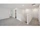Bright hallway features plush carpet, white walls, and a staircase leading to the lower level at 3970 Brushy St, Powder Springs, GA 30127