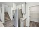 Kitchen stainless steel refrigerator next to pantry with gray cabinets and staircase in the background at 3970 Brushy St, Powder Springs, GA 30127