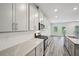 Modern kitchen with stainless steel appliances, white cabinets and countertops and light gray backsplash at 3970 Brushy St, Powder Springs, GA 30127