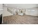 Expansive living space featuring hardwood floors, a staircase, and direct access to the kitchen area at 3970 Brushy St, Powder Springs, GA 30127