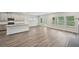 Open concept living room with kitchen island, stainless steel sink, and lots of natural light at 3970 Brushy St, Powder Springs, GA 30127