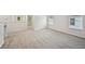 Open loft area with soft carpeting and natural light from windows creates a versatile space at 3970 Brushy St, Powder Springs, GA 30127