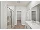 Bathroom features tiled shower, white cabinets, quartz countertops, and wood-look floors at 3974 Brushy St, Powder Springs, GA 30127
