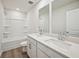 Bright bathroom featuring double sinks, quartz countertops, and a tub and shower combination at 3974 Brushy St, Powder Springs, GA 30127