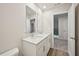 Clean bathroom boasts double vanity with white cabinets and neutral countertops at 3974 Brushy St, Powder Springs, GA 30127