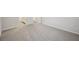 Open bedroom space with neutral walls and carpet that leads to the bathroom at 3974 Brushy St, Powder Springs, GA 30127