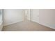 Bedroom featuring neutral carpet, white walls, and doors leading to the bathroom at 3974 Brushy St, Powder Springs, GA 30127