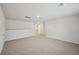 Spacious bonus room with neutral carpet, white walls, and ample natural light from the windows at 3974 Brushy St, Powder Springs, GA 30127