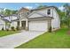 Charming two-story home boasts stone accents, a two-car garage, and a lush lawn at 3974 Brushy St, Powder Springs, GA 30127