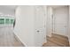 Hallway with hardwood floors leading to a living area featuring natural light at 3974 Brushy St, Powder Springs, GA 30127