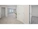 Bright hallway features neutral carpet, doors, and leads to a sunlit room with large windows at 3974 Brushy St, Powder Springs, GA 30127