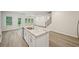 Bright kitchen featuring island, stainless steel appliances, and hardwood floors at 3974 Brushy St, Powder Springs, GA 30127