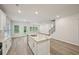 Bright open-concept kitchen featuring a large island, stainless steel appliances, and hardwood flooring at 3974 Brushy St, Powder Springs, GA 30127