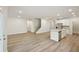 Bright living room with hardwood floors and a staircase, flowing into a kitchen space at 3974 Brushy St, Powder Springs, GA 30127