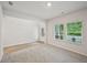 Bright living room featuring neutral carpet, natural light, and an exterior door at 3974 Brushy St, Powder Springs, GA 30127