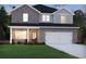 Charming two-story home features a gray brick facade, covered porch, and two-car garage at 4009 Brushy St, Powder Springs, GA 30127