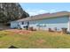 View of the back of a light blue house with a patio, yard, and exterior features at 4585 Post Ridge Ln, Lithonia, GA 30038