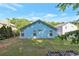 View of the backyard with light blue siding on the house and a grassy area at 4585 Post Ridge Ln, Lithonia, GA 30038