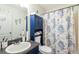 Well-lit bathroom with a modern vanity, blue cabinet, and stylish shower curtain at 4585 Post Ridge Ln, Lithonia, GA 30038