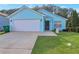 Charming single-story home with a well-maintained lawn, attached two-car garage, and light blue exterior at 4585 Post Ridge Ln, Lithonia, GA 30038