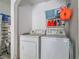 Functional laundry room with washer, dryer, and storage shelves for cleaning supplies and laundry essentials at 4585 Post Ridge Ln, Lithonia, GA 30038
