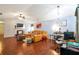Spacious living room with hardwood floors, a vaulted ceiling, modern lighting, and a comfortable seating area at 4585 Post Ridge Ln, Lithonia, GA 30038