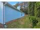 Side view of a light blue home, showcasing lush landscaping and a well-maintained lawn at 4585 Post Ridge Ln, Lithonia, GA 30038
