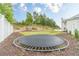 Expansive backyard featuring a large trampoline, play area and a privacy fence at 1349 Mckinsey Rdg, Loganville, GA 30052