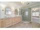 Bright bathroom featuring double sinks, gold fixtures and a shower with white tiling at 1349 Mckinsey Rdg, Loganville, GA 30052
