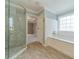 Relaxing bathroom featuring a soaking tub, white subway tile and a large window for natural light at 1349 Mckinsey Rdg, Loganville, GA 30052