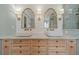 Elegant bathroom featuring a white marble countertop, double sink, tile accents and custom lighting at 1349 Mckinsey Rdg, Loganville, GA 30052