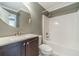 Cozy bathroom features a vanity, round mirror, and a shower-tub combination at 1349 Mckinsey Rdg, Loganville, GA 30052