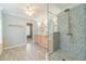 Luxurious bathroom featuring a glass enclosed shower, wooden cabinetry and fixtures with natural light at 1349 Mckinsey Rdg, Loganville, GA 30052