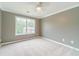 Comfortable bedroom boasts carpet, ceiling fan, and a bright window with outside view at 1349 Mckinsey Rdg, Loganville, GA 30052