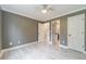 Spacious bedroom with light-colored flooring, ceiling fan, and ample closet space at 1349 Mckinsey Rdg, Loganville, GA 30052