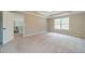 Neutral bedroom with a tray ceiling, view of the staircase and natural light shining through a window at 1349 Mckinsey Rdg, Loganville, GA 30052