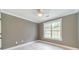Neutral bedroom featuring a ceiling fan, natural light, and light-colored flooring at 1349 Mckinsey Rdg, Loganville, GA 30052