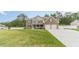 Traditional two-story brick home with a well-manicured lawn and attached two-car garage at 1349 Mckinsey Rdg, Loganville, GA 30052