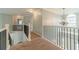 Bright upstairs hallway with iron railings and a chandelier visible in the background at 1349 Mckinsey Rdg, Loganville, GA 30052