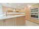 Bright kitchen featuring natural wood cabinetry, quartz countertops, stainless steel appliances, and a modern island at 1349 Mckinsey Rdg, Loganville, GA 30052