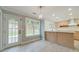 Eat-in kitchen area features a door to the exterior and a view into the spacious, remodeled kitchen at 1349 Mckinsey Rdg, Loganville, GA 30052