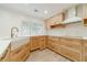 Well-lit kitchen showcases custom wood cabinets, stainless steel appliances, a farmhouse sink, and modern white countertops at 1349 Mckinsey Rdg, Loganville, GA 30052