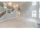Bright, open-concept living room with staircase, high ceilings, and large windows offering ample natural light at 1349 Mckinsey Rdg, Loganville, GA 30052