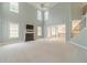 Bright living room features a fireplace, tall windows, and a view into the kitchen at 1349 Mckinsey Rdg, Loganville, GA 30052