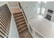 View from the staircase to living room, fireplace, and bright natural light at 1349 Mckinsey Rdg, Loganville, GA 30052