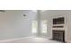 Bright and airy living room featuring tall ceilings and a fireplace with a mounted television at 1349 Mckinsey Rdg, Loganville, GA 30052
