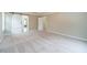 Spacious carpeted primary bedroom showcasing a barn door entry to an adjoining room, bathed in natural light at 1349 Mckinsey Rdg, Loganville, GA 30052