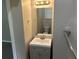 A bathroom featuring a vanity with a square sink, modern lighting, and a large mirror at 2076 Garden Cir, Decatur, GA 30032