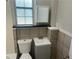 Small bathroom with tiled walls, single sink vanity, and a framed window at 2076 Garden Cir, Decatur, GA 30032