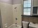 Bathroom with shower, toilet and small vanity under frosted glass window at 2076 Garden Cir, Decatur, GA 30032